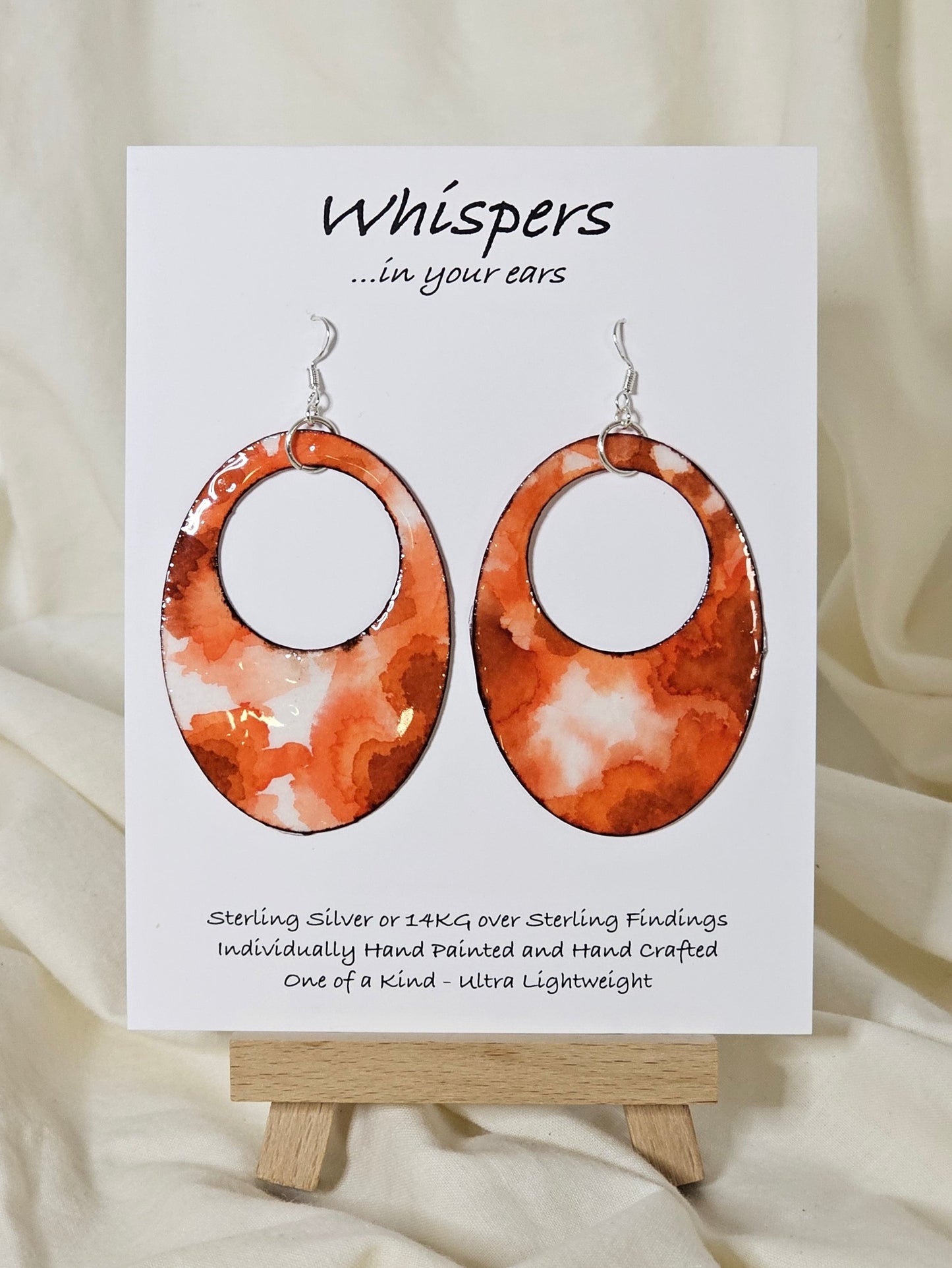 Hand painted watercolor ultra lightweight paper earrings. Deep orange and tangerine colors, organic shape inspired watercolor painting. Edge detailed in thin espresso brown color. Back is painted with the same color and design. 2" Large oval hoop in shape. Sterling silver findings. Hangs 2 3/4" in Length
