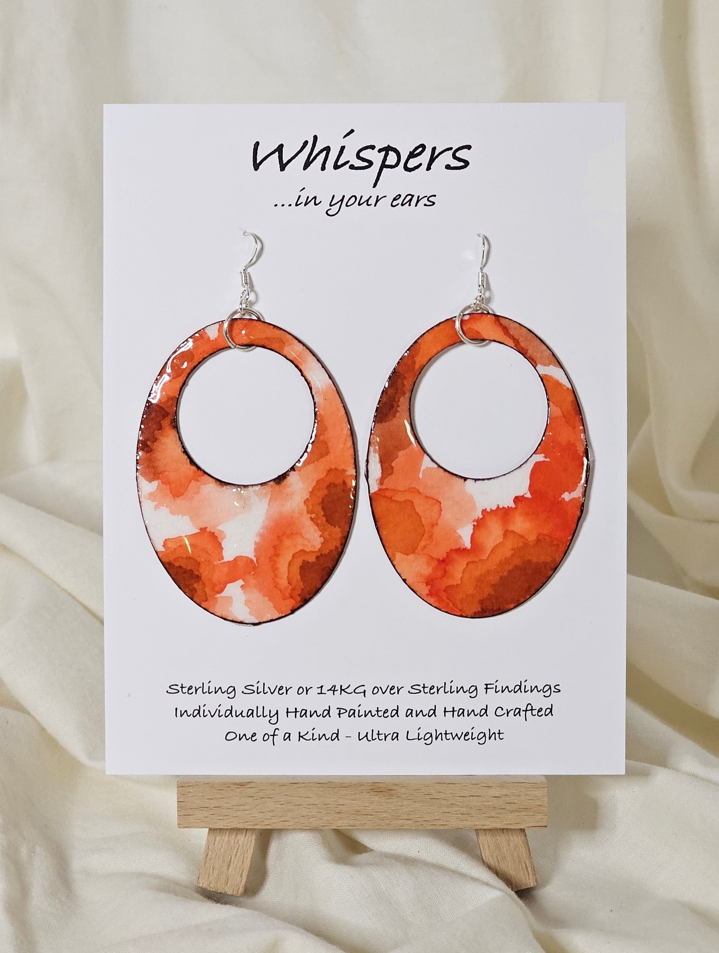 Hand painted watercolor ultra lightweight paper earrings. Deep orange and tangerine colors, organic shape inspired watercolor painting. Edge detailed in thin espresso brown color. Back is painted with the same color and design. 2" Large oval hoop in shape. Sterling silver findings. Hangs 2 3/4" in Length