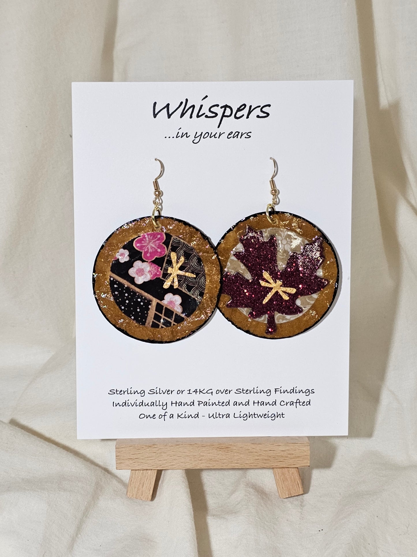 Golden Dragonfly Asian Maple Leaf Hand Painted Crafted Paper Earrings. Artisanal Papers, Hand painted with Gold dragonfly embellishment. Designs are the same on both side. Reversed in Placement. 2" Circular in shape. Resin coated for durability. 14 kg over Sterling silver findings. Hangs 2 1/4" in length