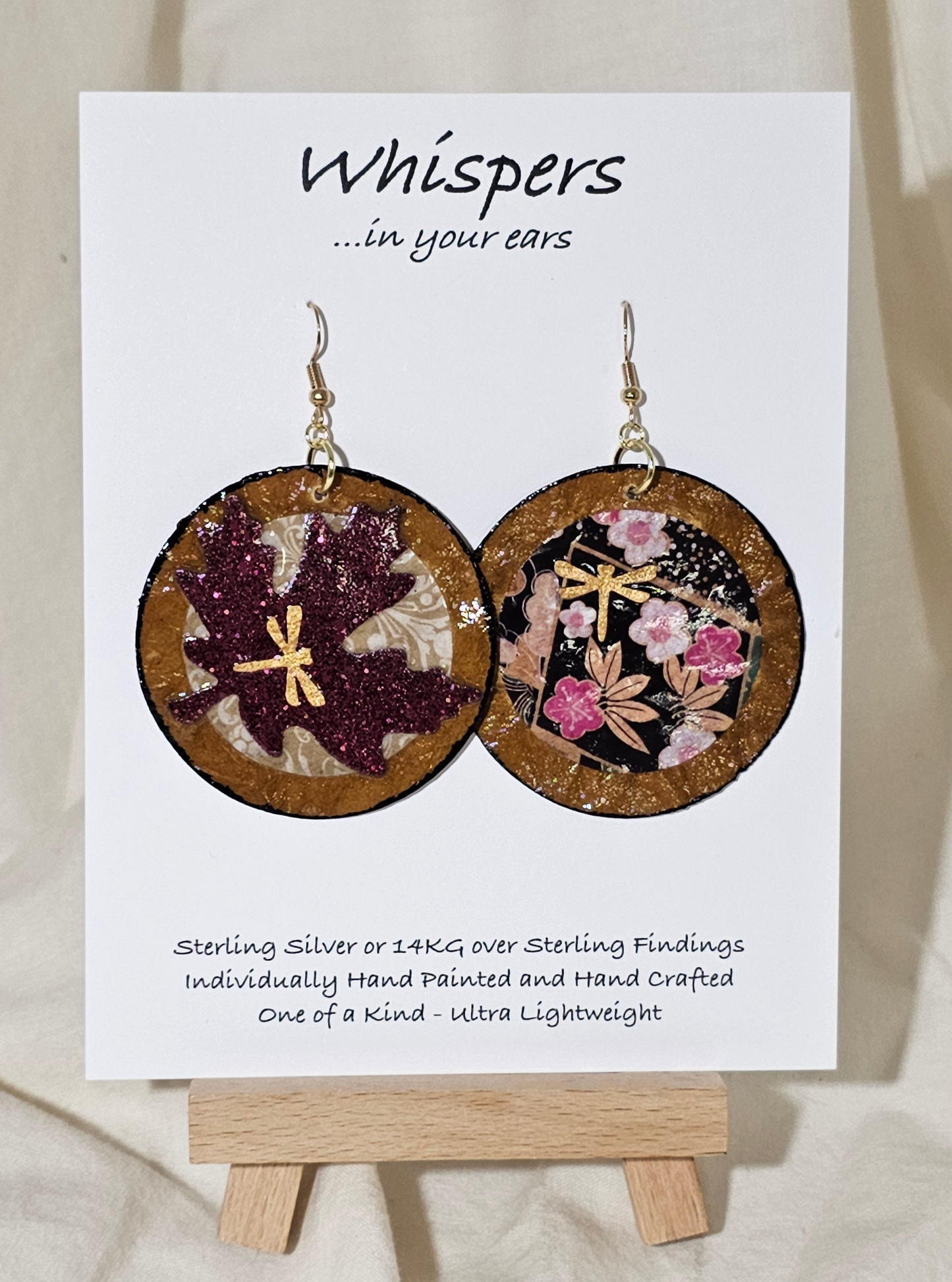Golden Dragonfly Asian Maple Leaf Hand Painted Crafted Paper Earrings. Artisanal Papers, Hand painted with Gold dragonfly embellishment. Designs are the same on both side. Reversed in Placement. 2" Circular in shape. Resin coated for durability. 14 kg over Sterling silver findings. Hangs 2 1/4" in length