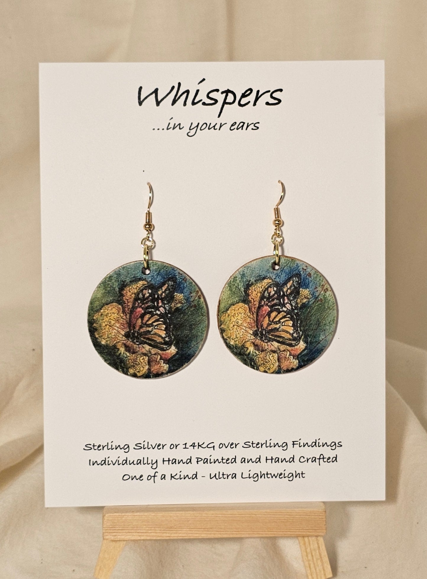 Butterfly Art Print Wood Earrings. Artwork by Lee M. Hein. 1 1/2" Circle. Back is painted brown wash. Enameled for durability. 14KG over Sterling findings. Hangs 1 3/4" in length