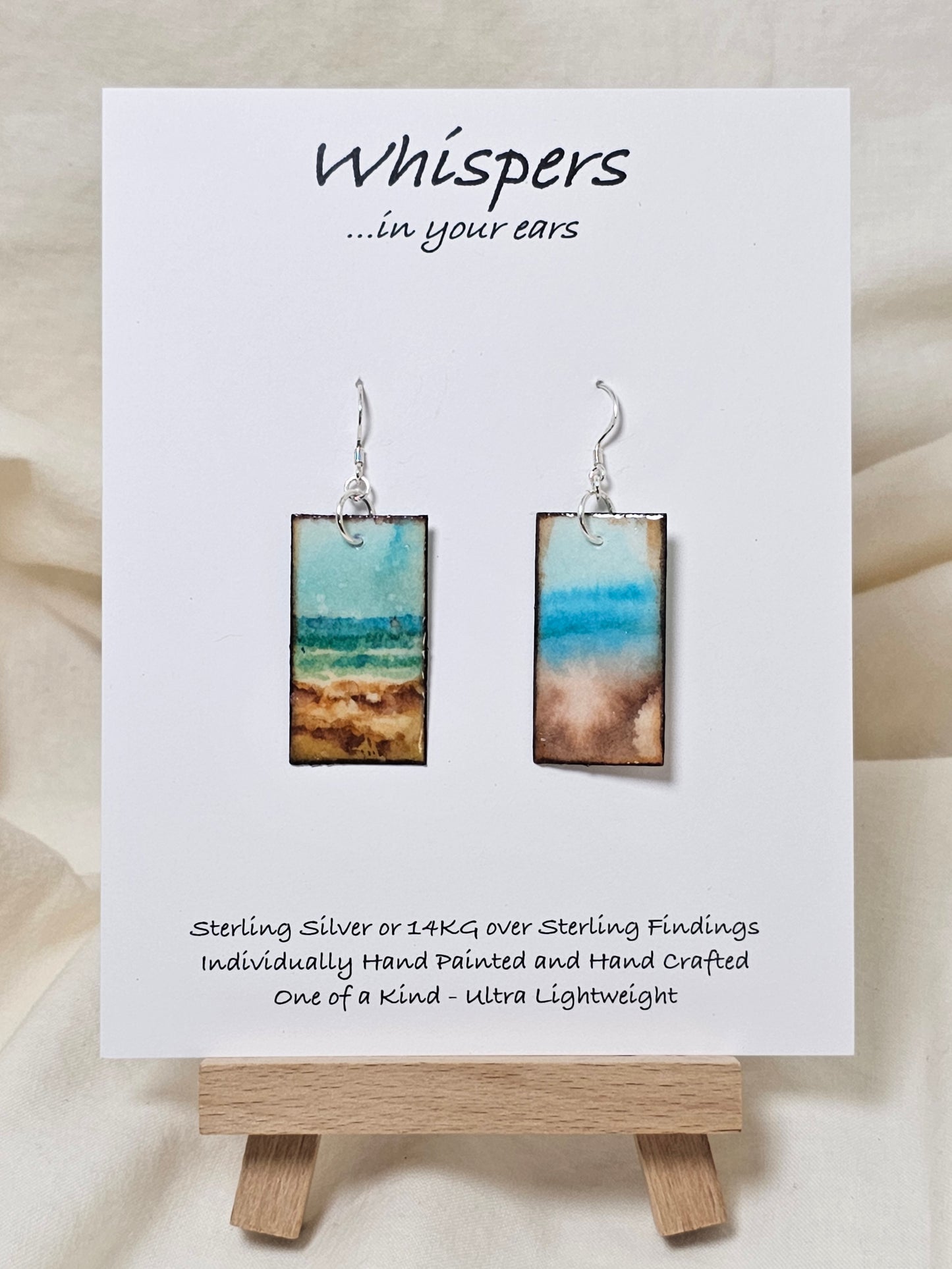 Vintage Beach Scape Hand Painted Paper Earrings. Ultra lightweight 1 3/8" Rectangle, painted in watercolor with aged paper look. Back painted with complimentary design. Resin coating for durability. Sterling Silver findings. Hangs 1 1/2" in length