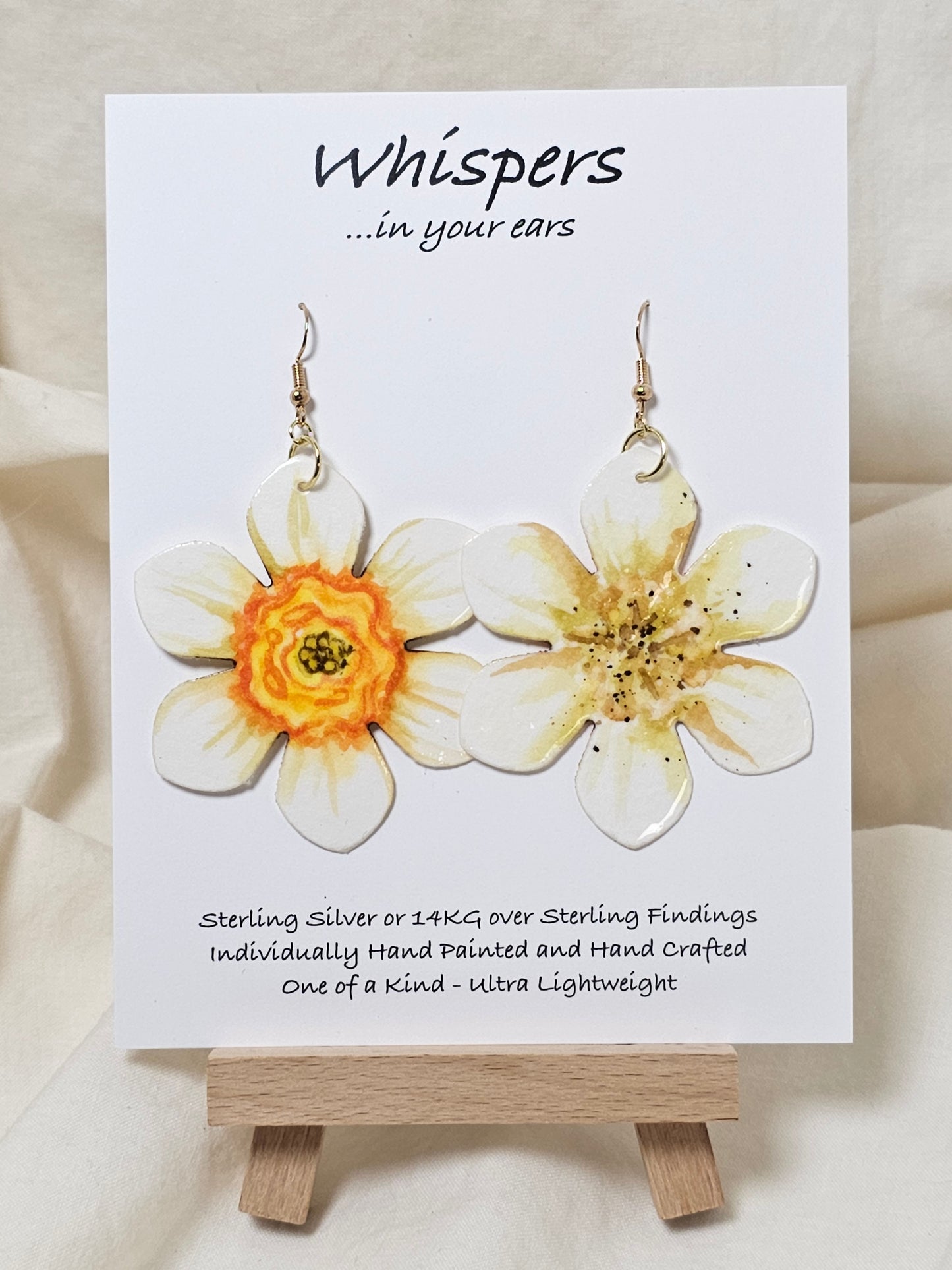 Natural Daffodil Flower Hand Painted Paper Earrings. Ultra lightweight 2 1/2" in diameter. Watercolor painted to resemble a yellow centered white daffodil. Back is painted in complimentary colors. Resin Coating for durability. Mixed metal findings. 14KG over sterling ear wires. Hangs 2 5/8" in length