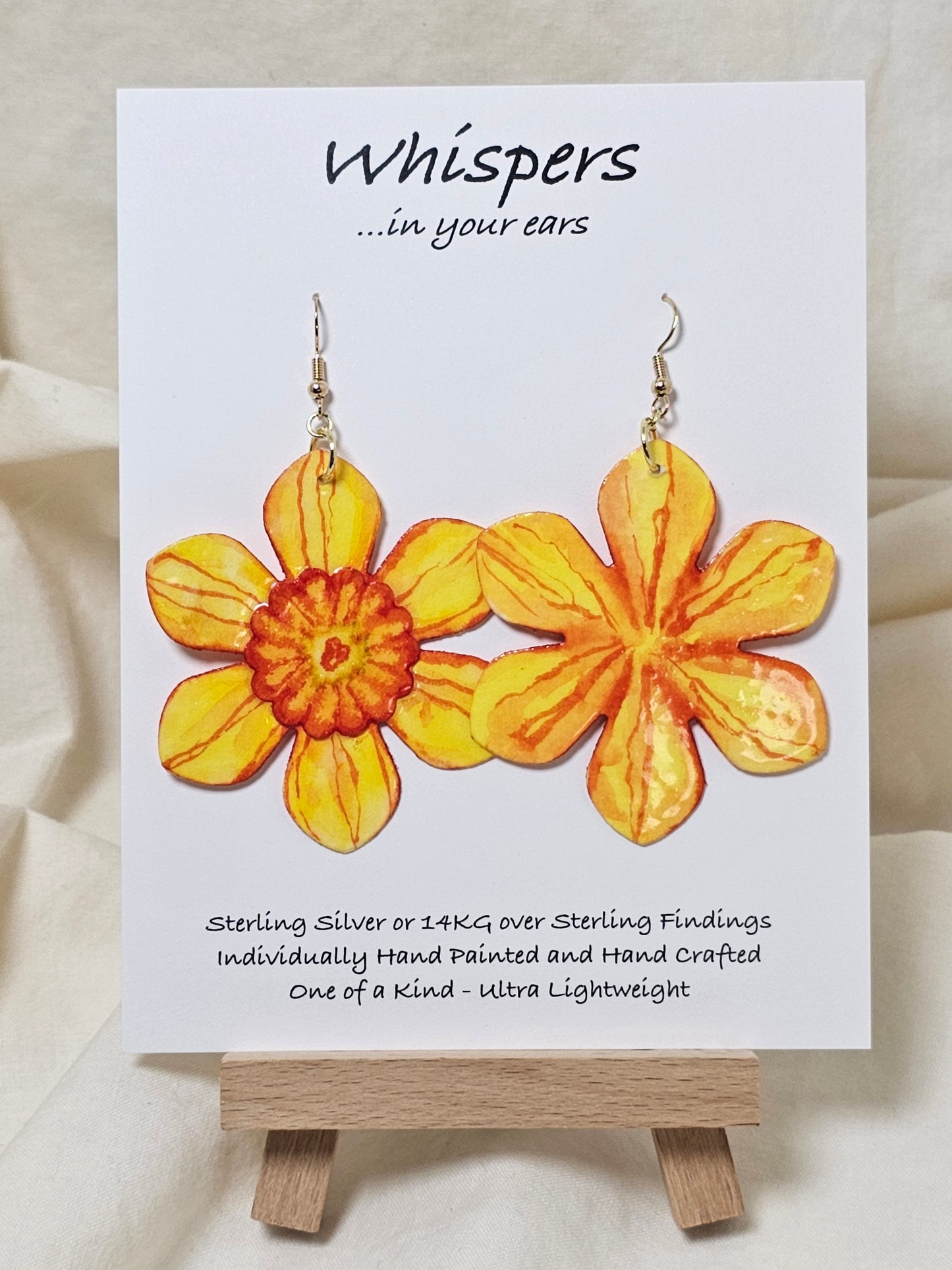 Orange Burst Layered Flower Hand Painted Paper Earrings. Ultra lightweight 2 1/2" in diameter. Watercolor painted to resemble bright Orange yellow flower with deep orange veining. Center is separate layer painted. Back is painted in complimentary colors. Resin Coating for durability. Mixed Metas 14KG over sterling and Sterling Silver findings. Hangs 2 5/8" in length