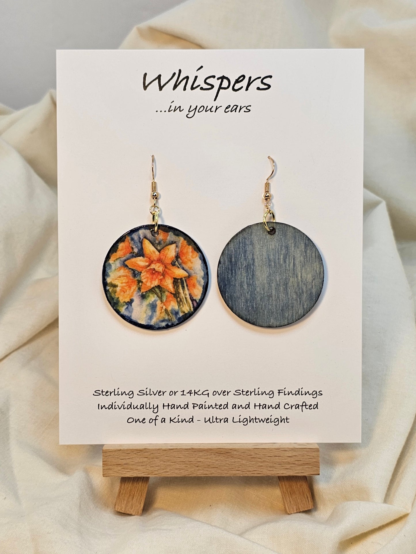 Daffodil Art Print Wood Earrings. Artwork by Lee M. Hein. Ultra lightweight 1 1/2" Circle. Back is painted with light blue wash. Edged in darker blue. Enameled for durability. Mixed metal 14KG over sterling and Sterling findings. Hangs 1 3/4" in length