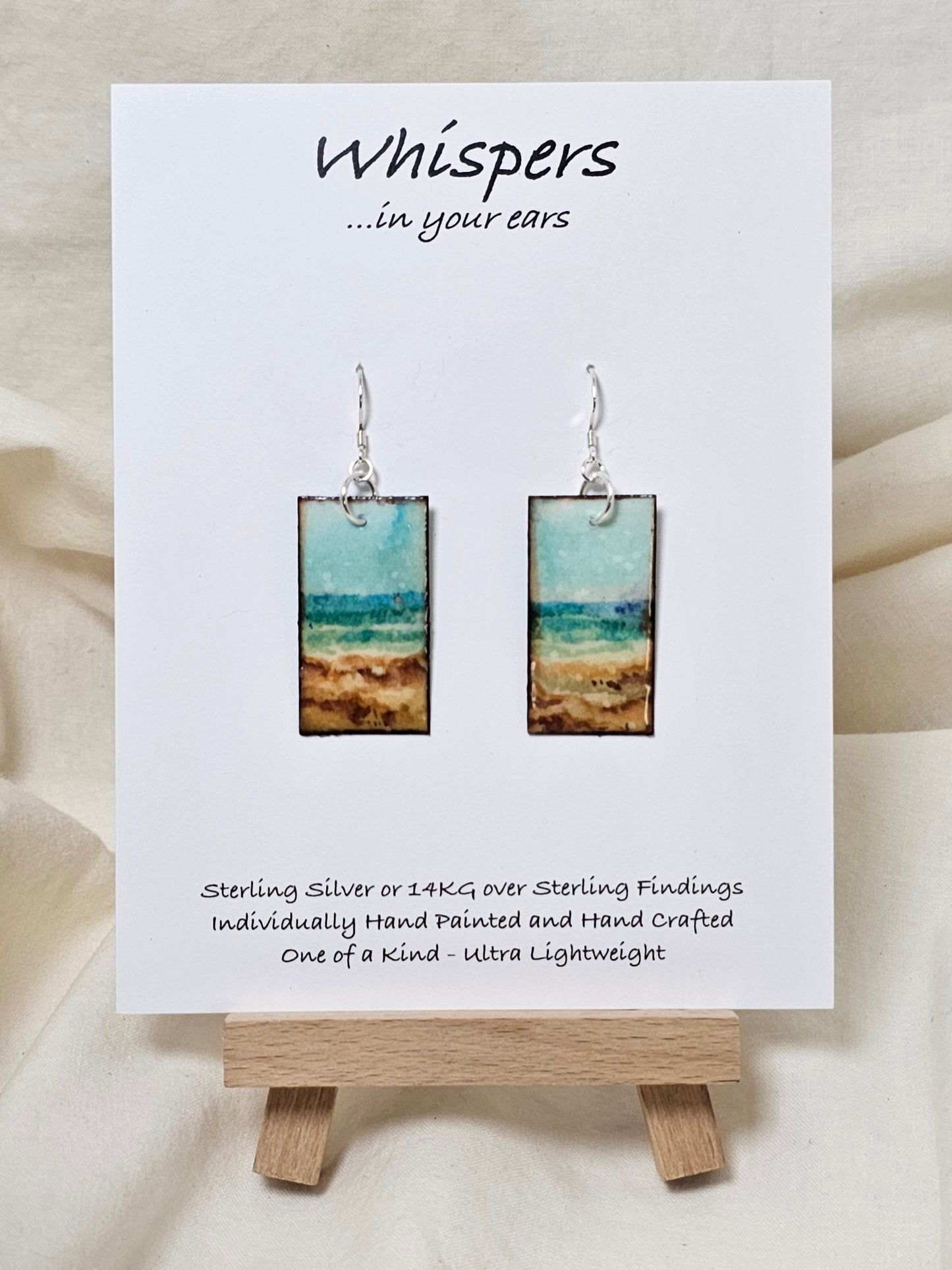 Vintage Beach Scape Hand Painted Paper Earrings. Ultra lightweight 1 3/8" Rectangle, painted in watercolor with aged paper look. Back painted with complimentary design. Resin coating for durability. Sterling Silver findings. Hangs 1 1/2" in length