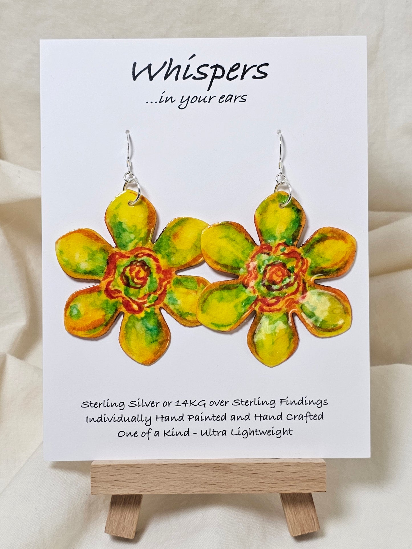 Pop Art Daffodil Flower Hand Painted Paper Earrings. Ultra lightweight 2 1/2" in diameter. Watercolor painted to resemble bright yellow and orange daffodil. Back is painted in complimentary colors. Resin Coating for durability. Sterling Silver findings. Hangs 2 5/8" in length