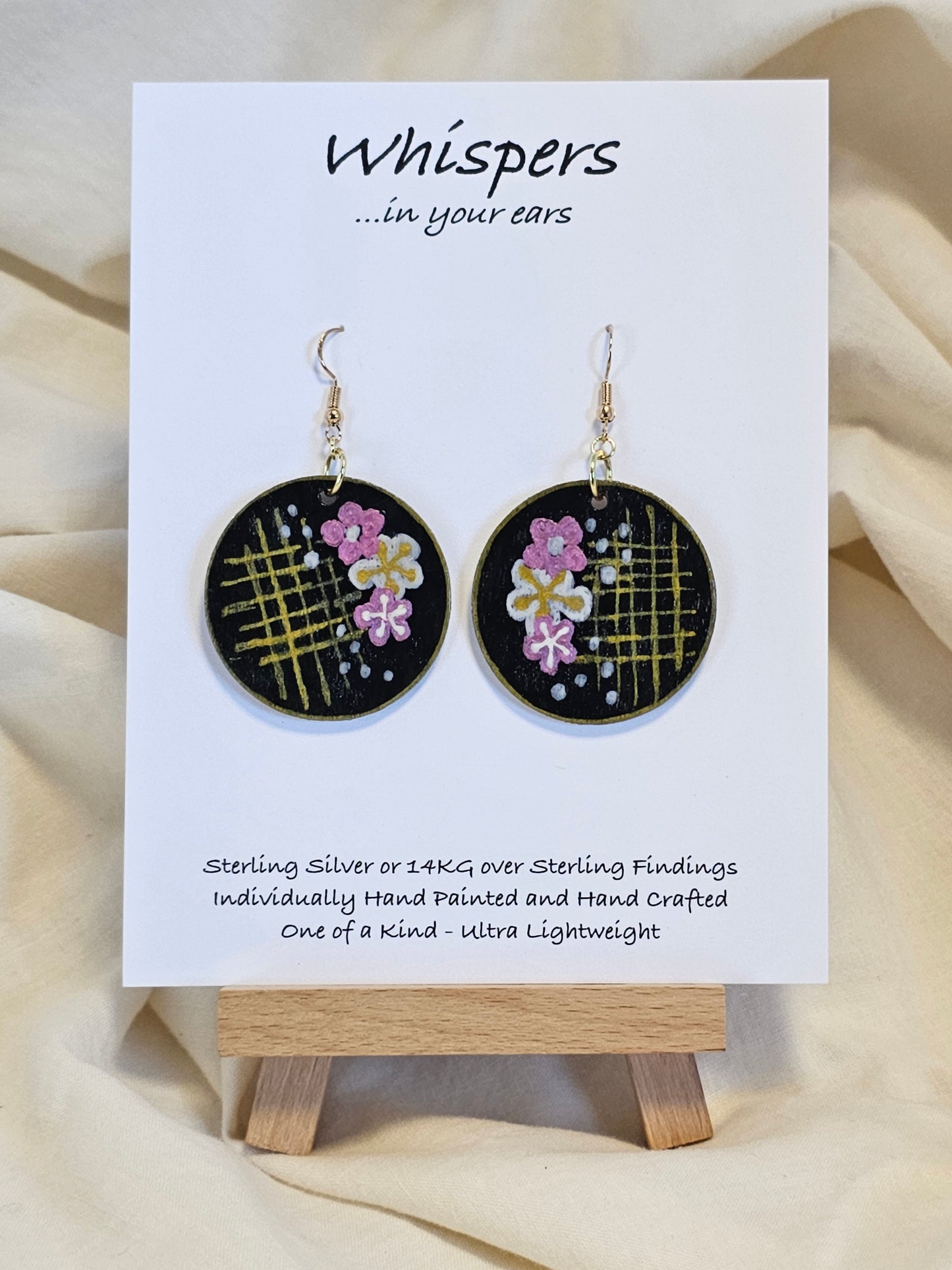 Cherry Blossom Grid Hand Painted/Crafted Wood Earrings. 1 1/2" Wood Disc with handmade paper with painted cherry blossoms painted gold edges. Resin Coating for durability. Back is done to compliment. 14kg over sterling ear wire sterling silver findings. Hangs 1 3/4"