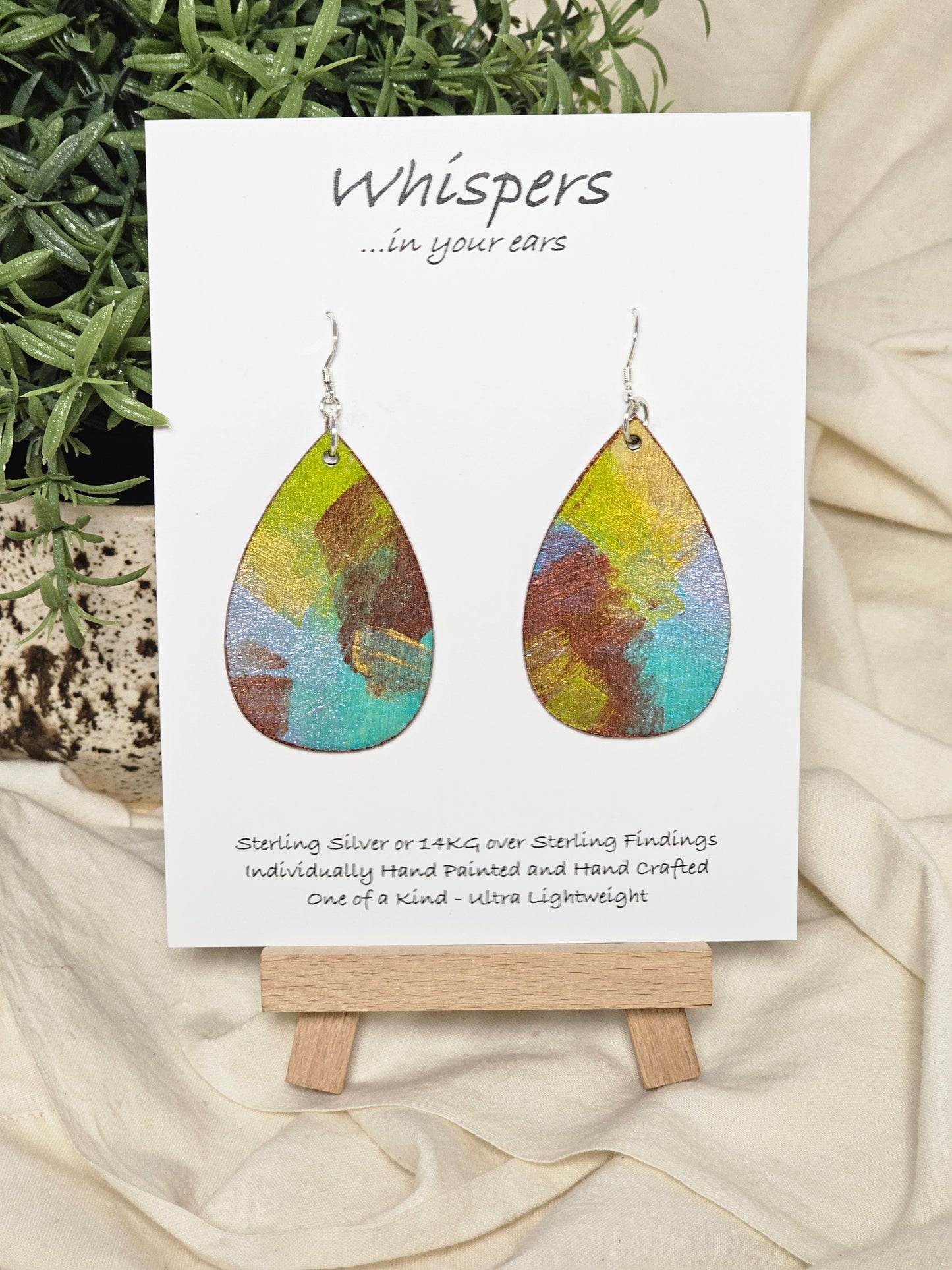 Iridescent Swipe Hand Painted Wood Earrings. 2" Wood Teardrop, painted with iridescent acrylics, Back is painted to match. Enameled for durability. Sterling silver findings. Hangs 2 1/4" in length