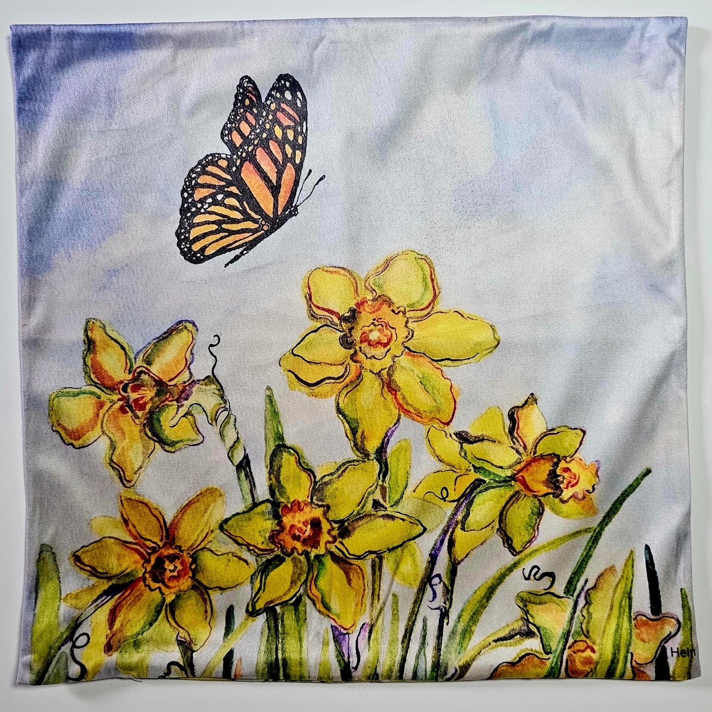Decorative fabric with yellow flowers and a butterfly on a white and sky blue background