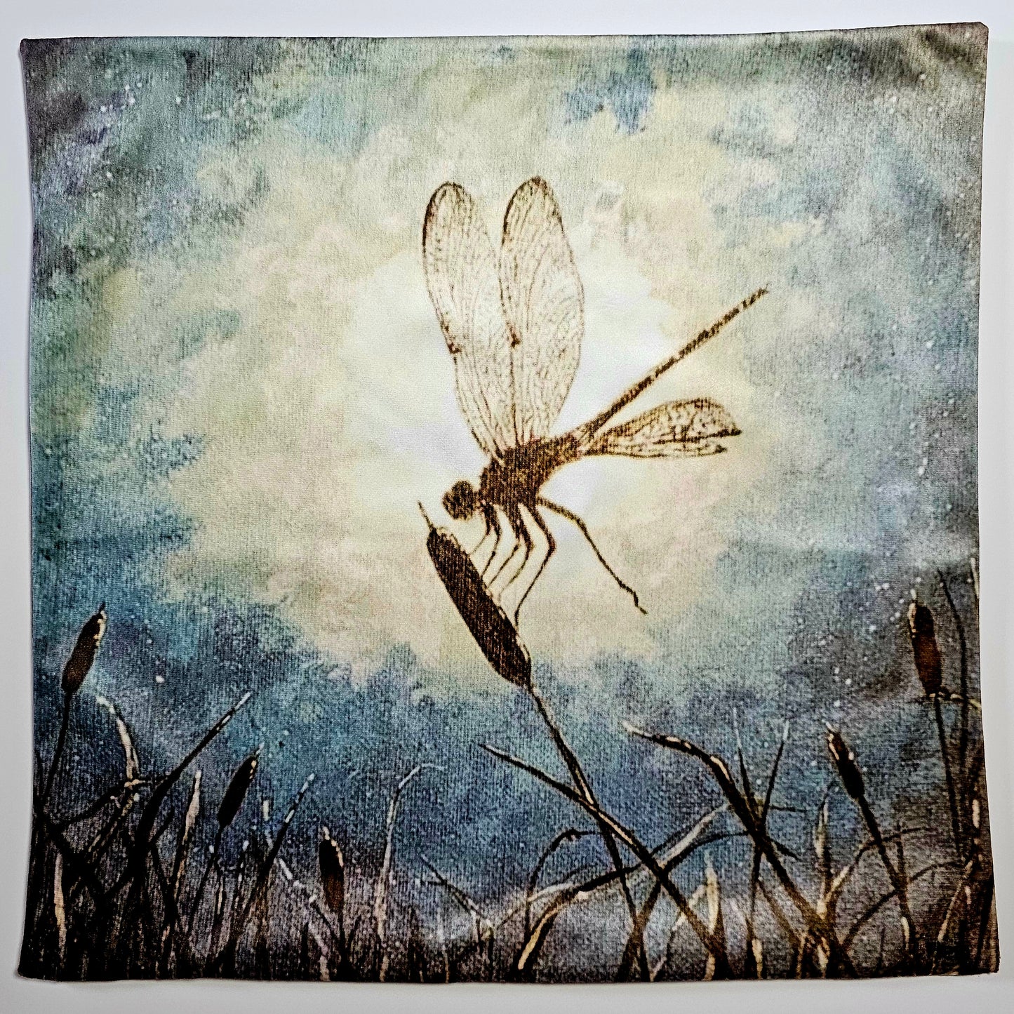 Artistic Silhouette depiction of a dragonfly landing on a cat tail in the moonlight