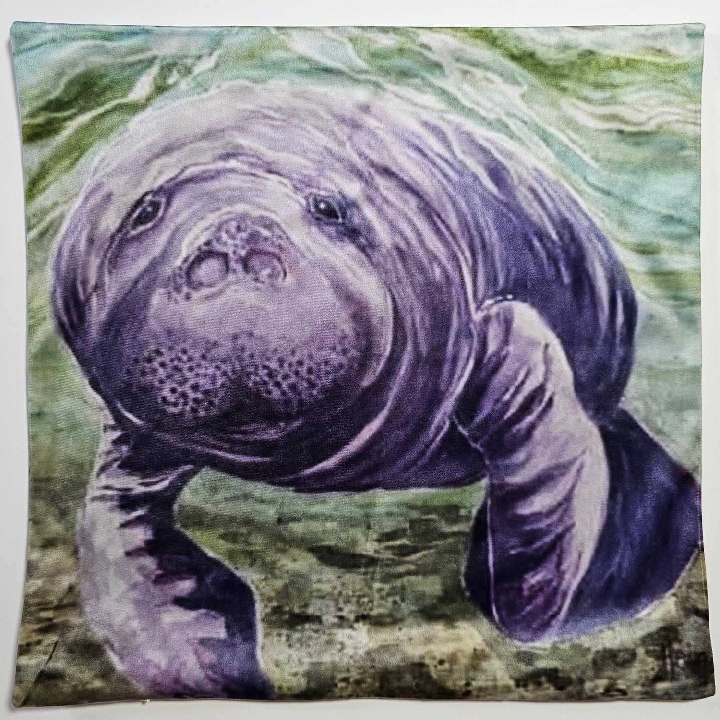 Manatee under water with a green and brown background
