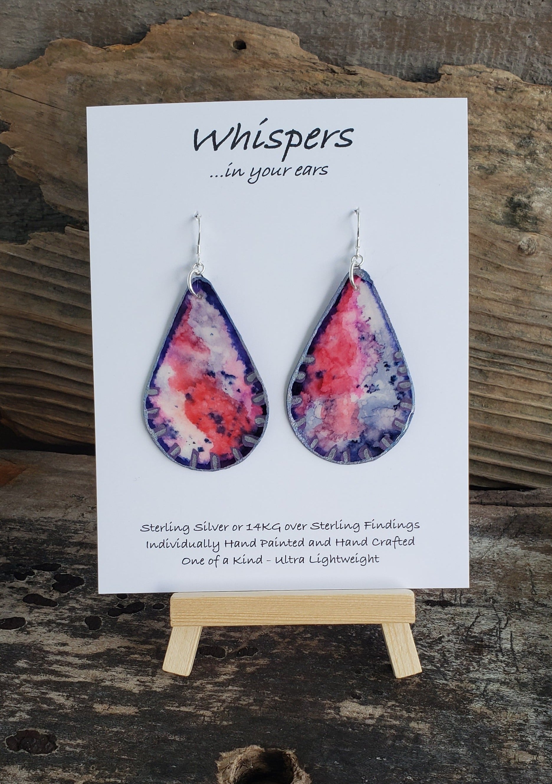 Hand painted watercolor ultra lightweight earrings. Purple and pink design to resemble a Kunzite Gemstone. Edges painted with Silver acrylic detail. Back is painted with a similar design. Teardrop in shape. Hangs 2 1/4" in Length