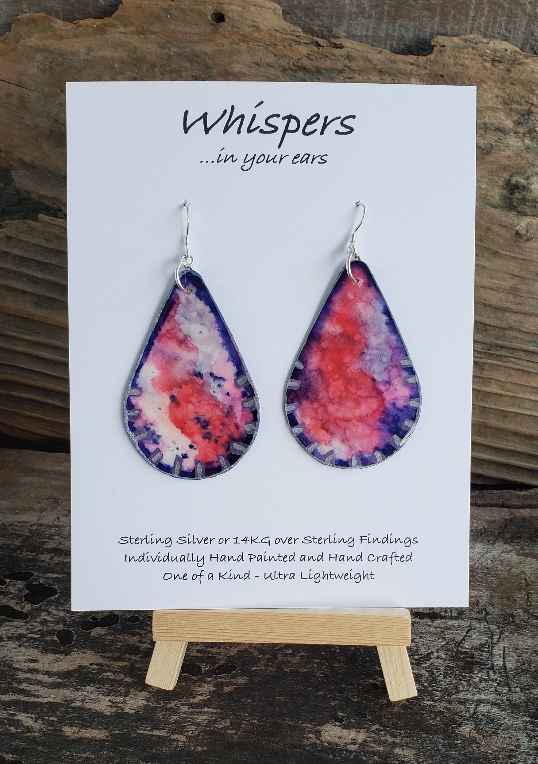 Hand painted watercolor ultra lightweight earrings. Purple and pink design to resemble a Kunzite Gemstone. Edges painted with Silver acrylic detail. Back is painted with a similar design. Teardrop in shape. Hangs 2 1/4" in Length