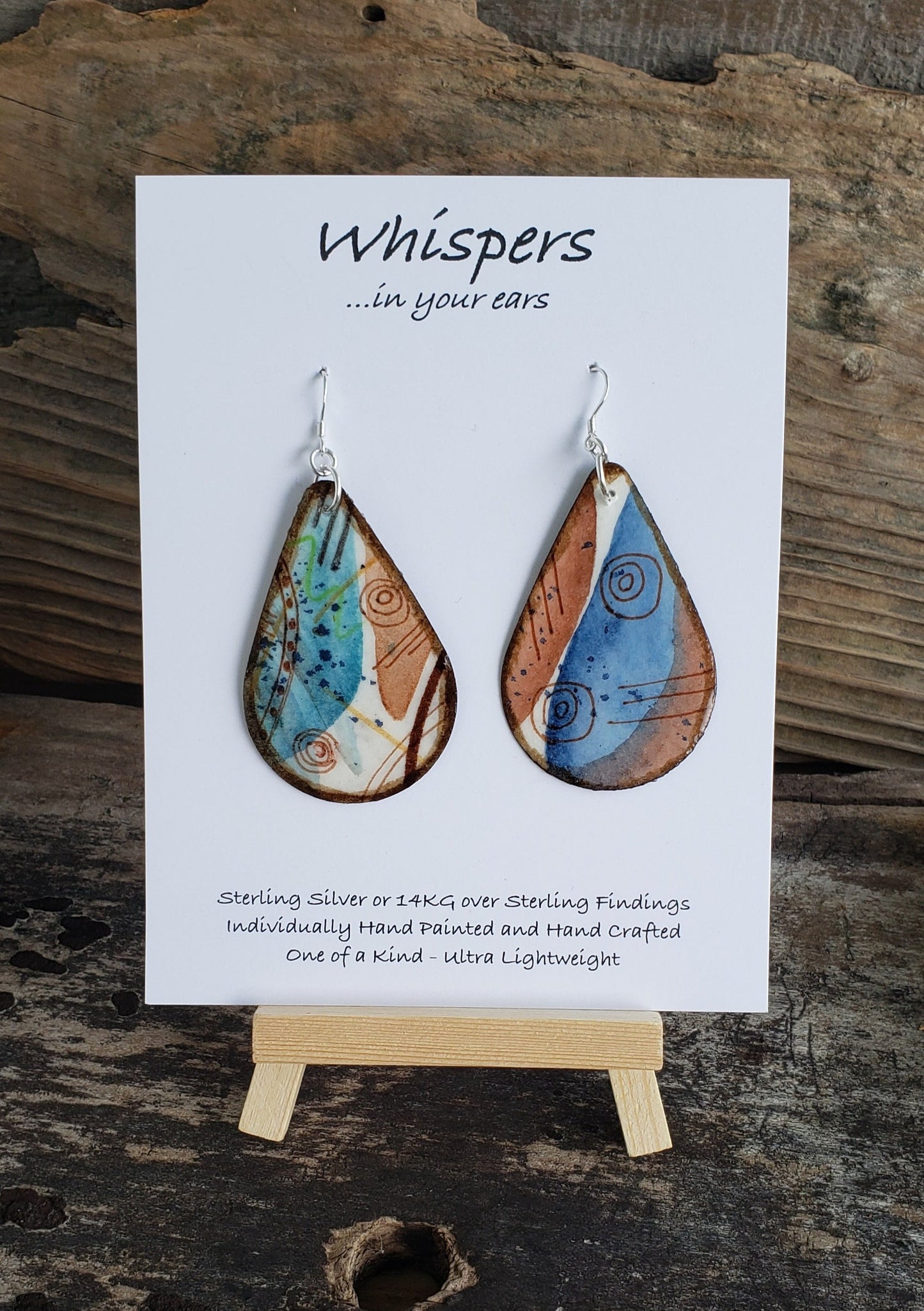Hand painted watercolor ultra lightweight paper earrings. Aqua blue and brown wash. Dots and swirl designs. Dark brown edge detail. Back is painted with similar colors and design. Tear drop in shape. Sterling silver findings. Hangs 2 1/4" in Length