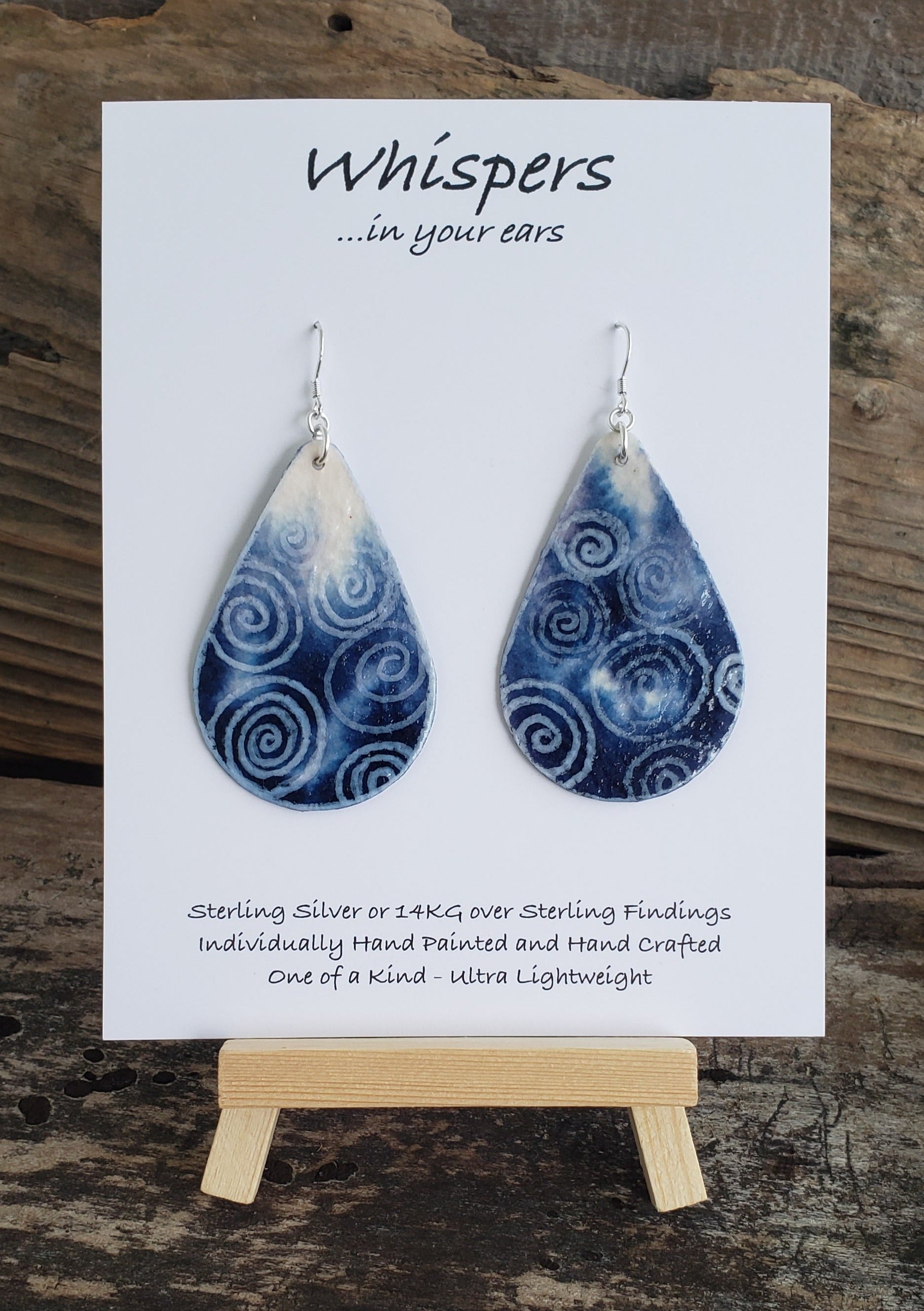 Hand painted watercolor ultra lightweight paper earrings. Deep blue ombre with white swirl accents. Teardrop in shape. Back is painted wit similar color. Sterling silver findings. Hangs 2 1/4" in Length