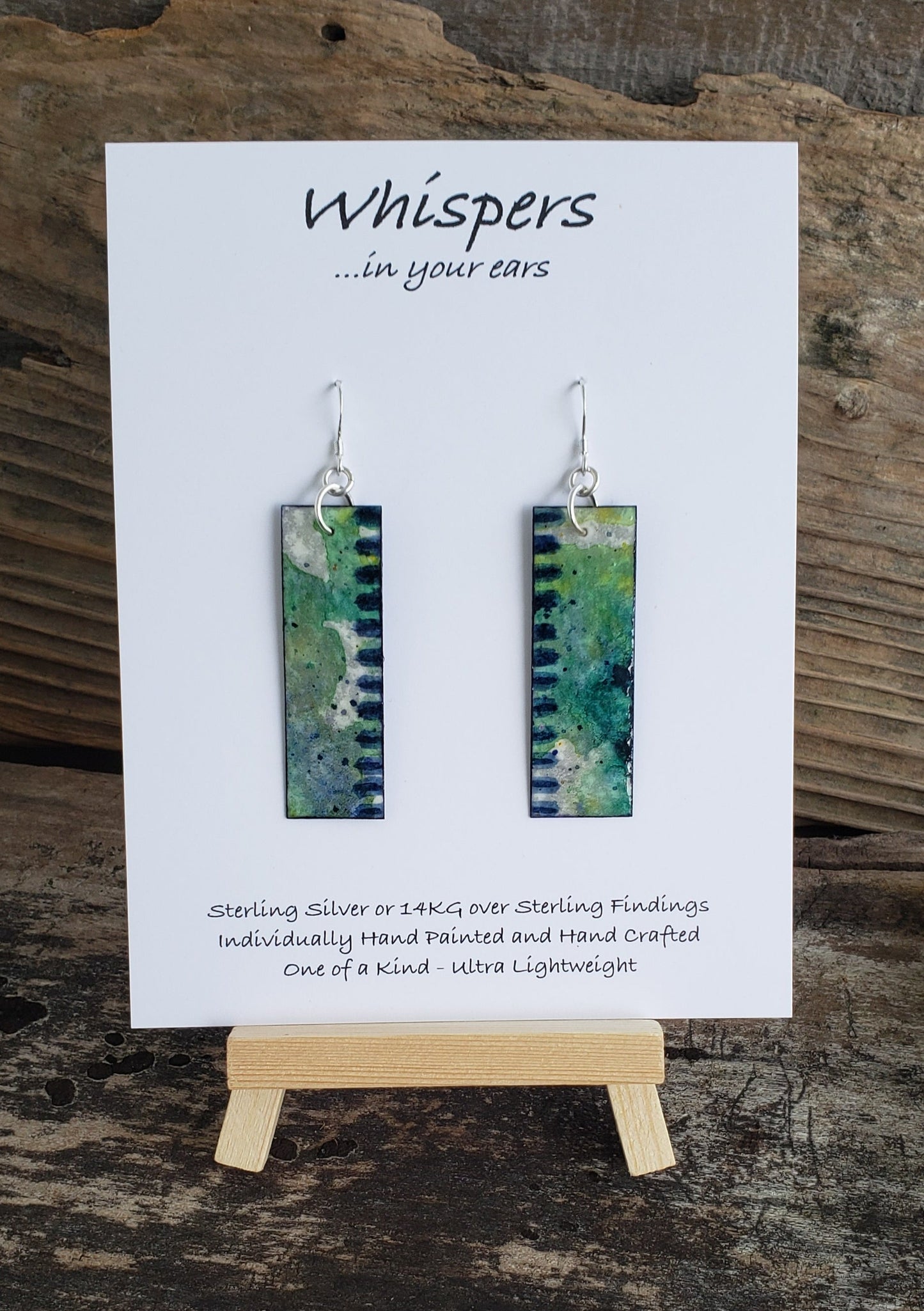 Hand painted watercolor ultra lightweight earrings. Painted  layers of earthy blues and greens with blue stiped edging. Back is painted with complimentary color navy blue and white accent edging.  Elongated rectangle in shape. Sterling silver findings. Hangs 2 1/8" in Length