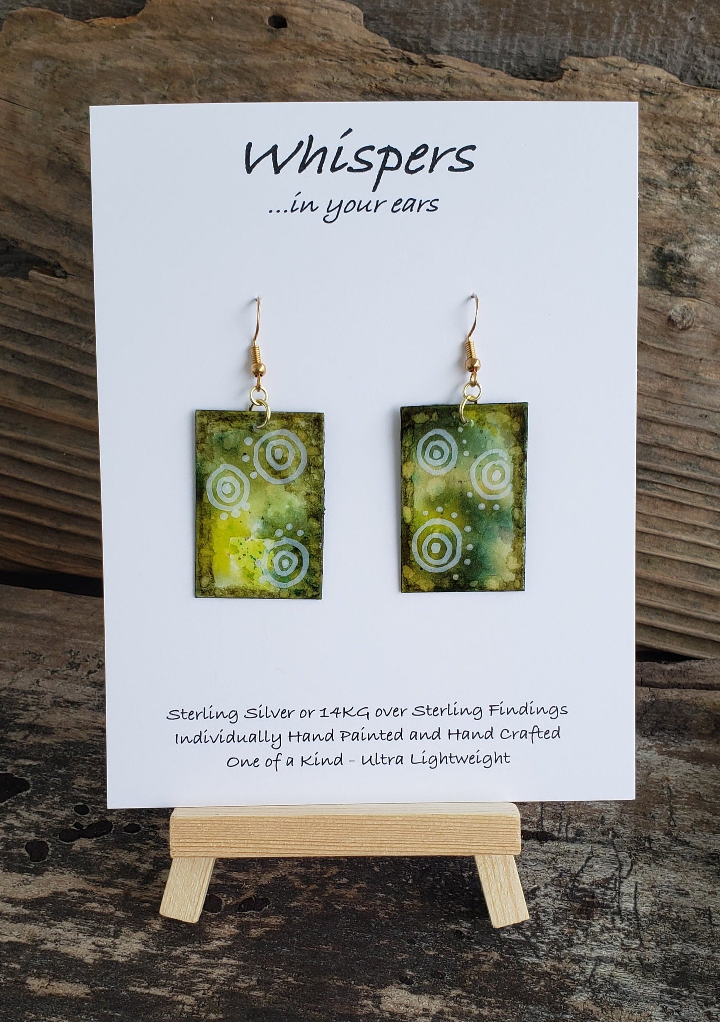Hand painted watercolor ultra lightweight paper earrings. Greens with white swirly dot accents. Rectangular in shape. Back is painted with complimentary colors. 14kg over silver findings. 1 5/8" in Length