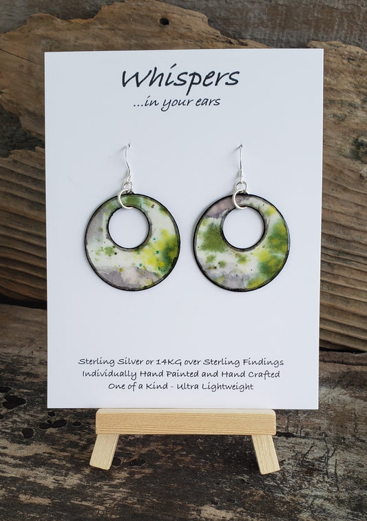 Hand painted watercolor ultra lightweight paper earrings. Abstract deign of ice covered greens. Circular in shape with circular cut out. Grey painted edges. Back is painted in black. Sterling silver findings. Hangs 1 1/2" in Length