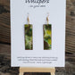 Hand painted watercolor ultra lightweight paper earrings. Muted green tones with copper painted accent rings. Back is painted copper in color. Elongated rectangle in shape. 14kg over silver findings. Hangs 2 1/4" in Length
