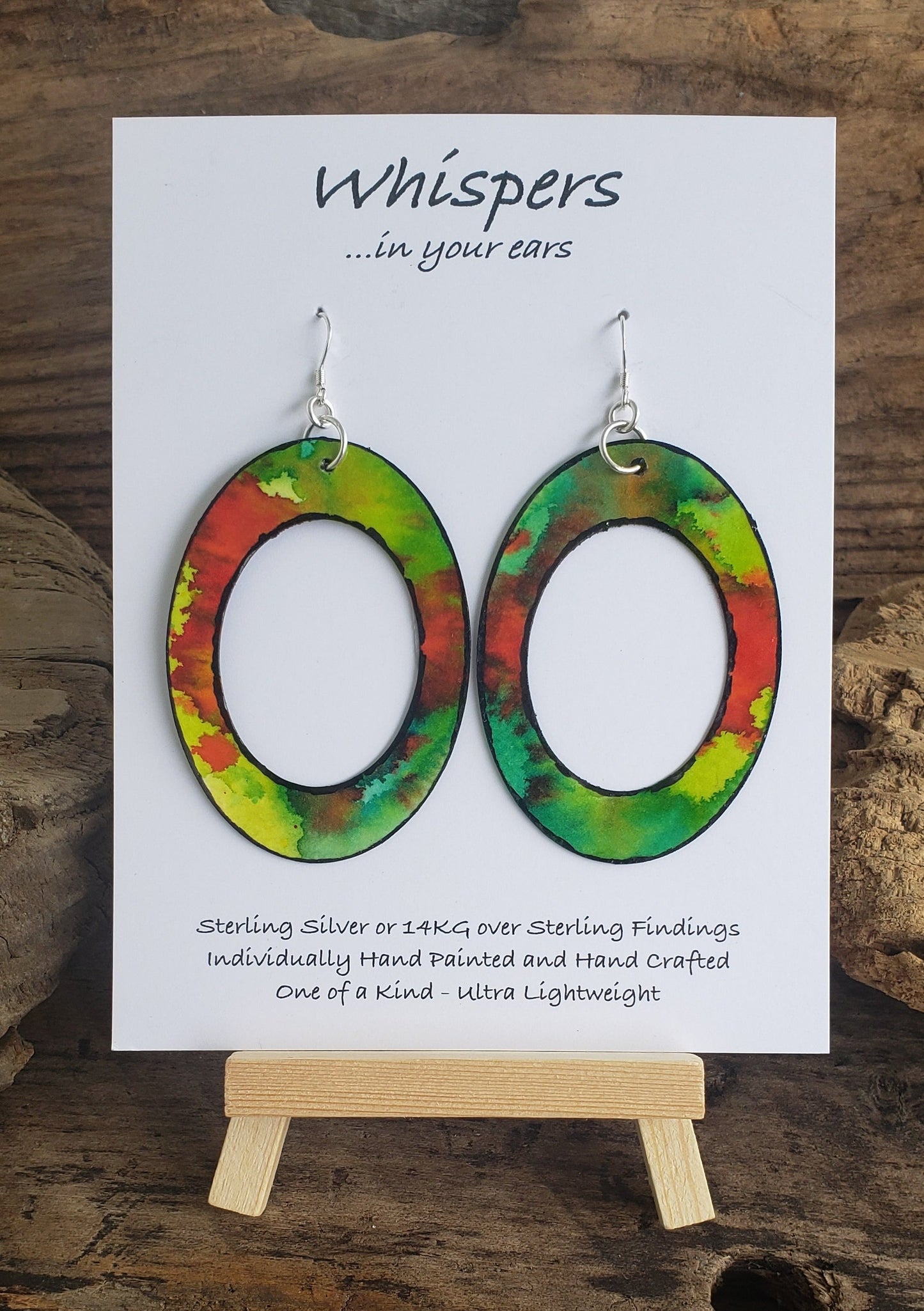 Hand painted watercolor ultra lightweight paper earrings. Graffiti style red splotch layered with bright greens. Edge detailed in black. Back is painted black. Large Statement oval with oval cut out. Sterling silver findings. Hangs 2 3/4" in Length