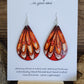 Hand painted watercolor abstract Feathery wings. Ultra lightweight paper earrings. Golden yellow, burnt orange, reds and browns. Tear drop in shape. Back is painted similar in style with complimentary colors. Sterling silver findings. 2 1/2" in Length