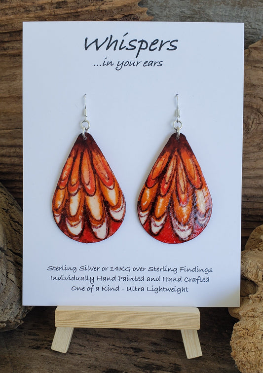 Hand painted watercolor abstract Feathery wings. Ultra lightweight paper earrings. Golden yellow, burnt orange, reds and browns. Tear drop in shape. Back is painted similar in style with complimentary colors. Sterling silver findings. 2 1/2" in Length