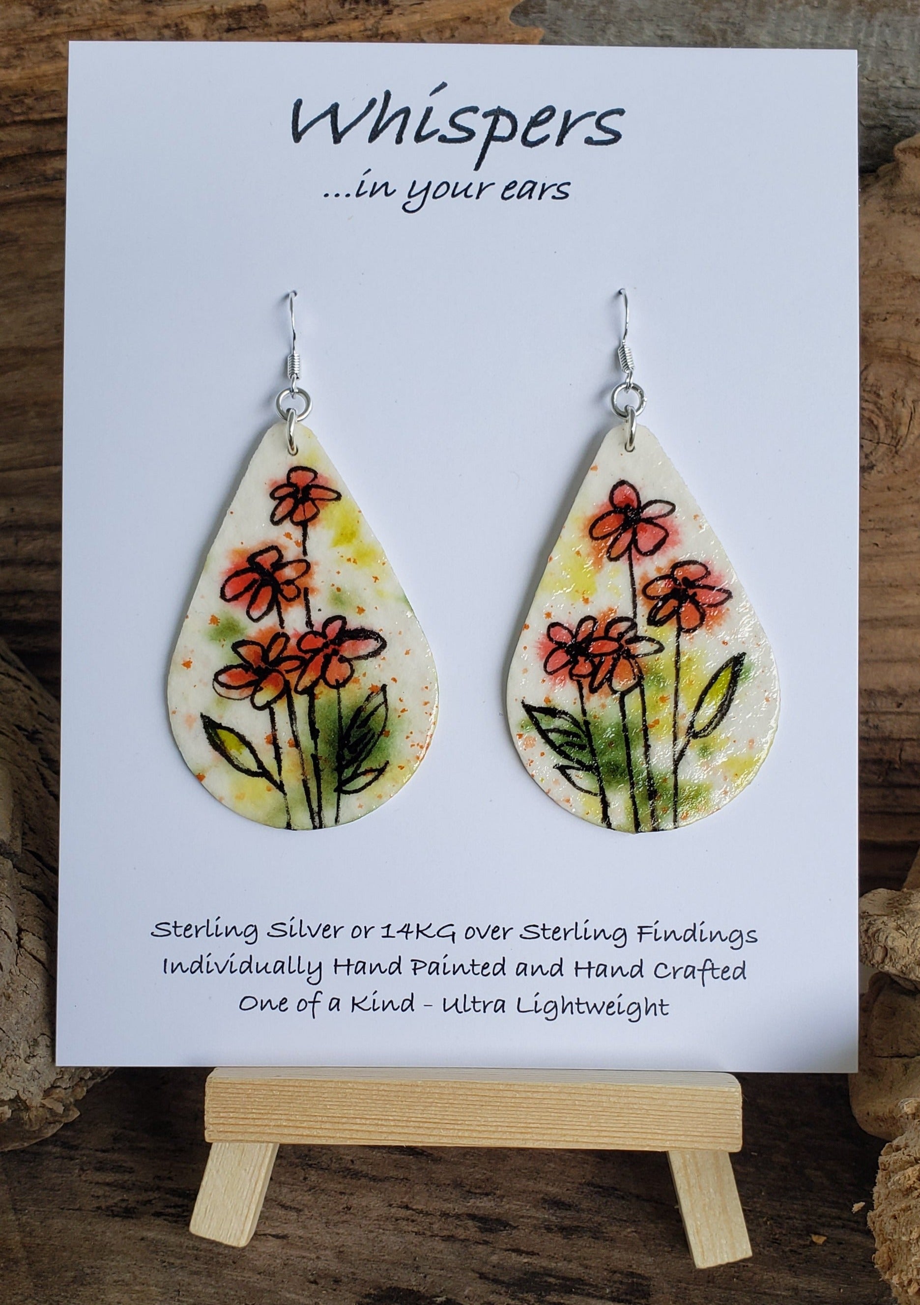 Hand painted watercolor paper earrings. Whimsical Floral Design with faded background. Tear drop shape. Back is painted with complimentary colors. Sterling Silver findings. 2 1/2" in Length