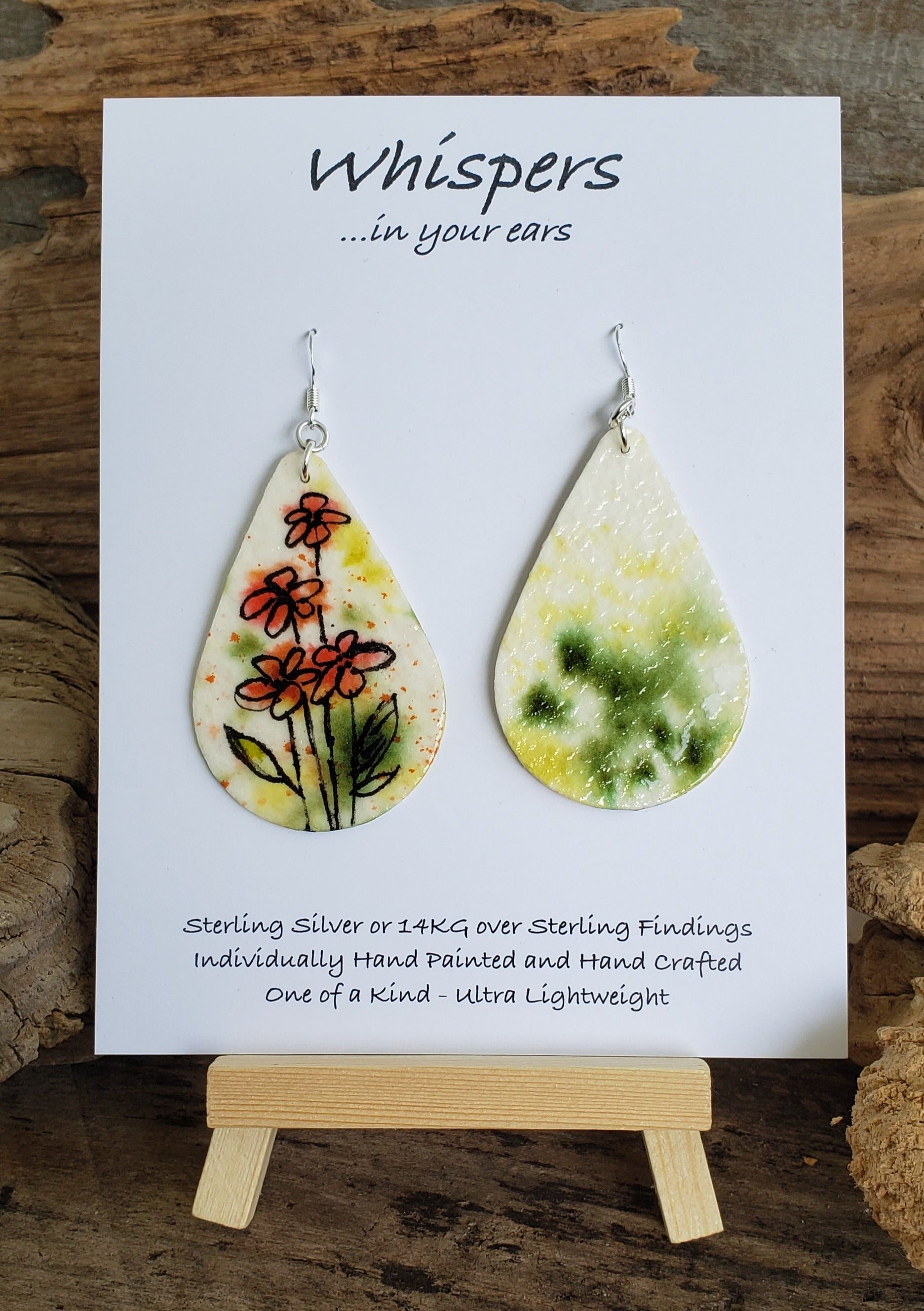 Hand painted watercolor paper earrings. Whimsical Floral Design with faded background. Tear drop shape. Back is painted with complimentary colors. Sterling Silver findings. 2 1/2" in Length