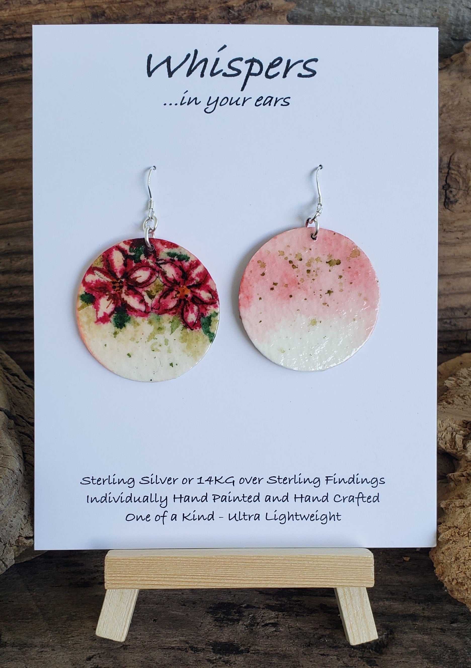 Hand painted watercolor ultra lightweight paper earrings. Crimson lilies with muted green background. Back is painted with similar background colors. Sterling silver findings. 1 1/2" Circular in shape. Hangs 1 3/4" in Length