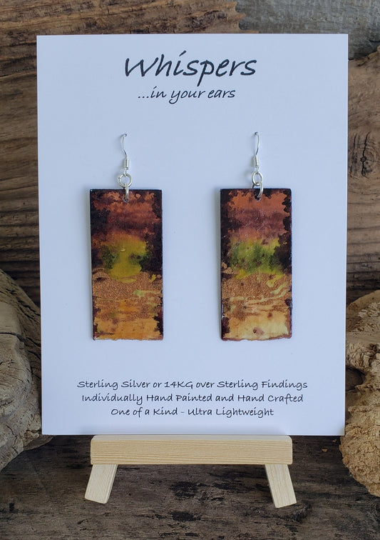 Hand painted watercolor Forrest nature scape. Metallic acrylic embellishment. Organic bottom edge. Back is painted in similar colors. Rectangular in shape. Sterling silver findings. Hangs 2 1/4" in Length