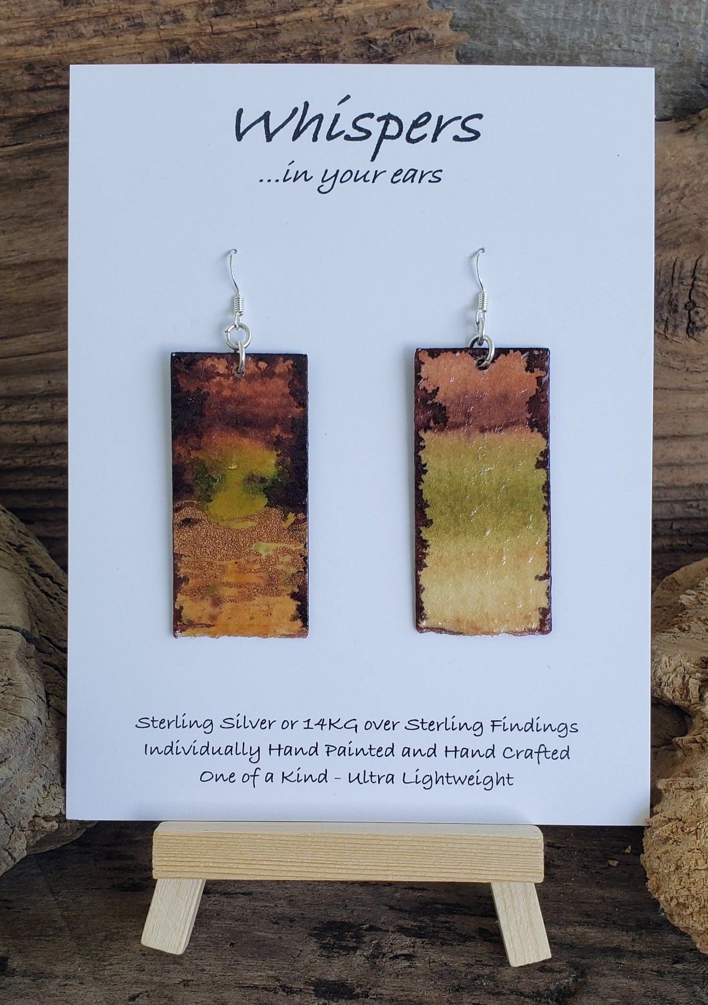 Hand painted watercolor Forrest nature scape. Metallic acrylic embellishment. Organic bottom edge. Back is painted in similar colors. Rectangular in shape. Sterling silver findings. Hangs 2 1/4" in Length