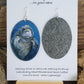 Artist print of Manatee by artist Lee M. Hein. Ultra lightweight paper earrings. Painted with silver embellishment. Back is grey iridescent textural paper. Sterling silver findings. Large statement oval in shape. Hangs 2 5/8" in Length