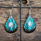 Hand painted watercolor/acrylic Moonlit Forest. Ultra lightweight paper earrings. Nature scape Moon through teal blue sky with  forest silhouette detail.  Back is painted in a complimentary color. Teardrop in shape. Sterling silver findings. Hangs 2 1/2" in Length
