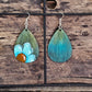 Hand Painted Ultra Lightweight Wooden Earrings. Watercolor and Acrylic. Muted green background with Turquoise Blue Daisy Flower. Teardrop in shape. Back is painted in complimentary color. Sterling Silver Findings. Hangs 2 1/4" in Length