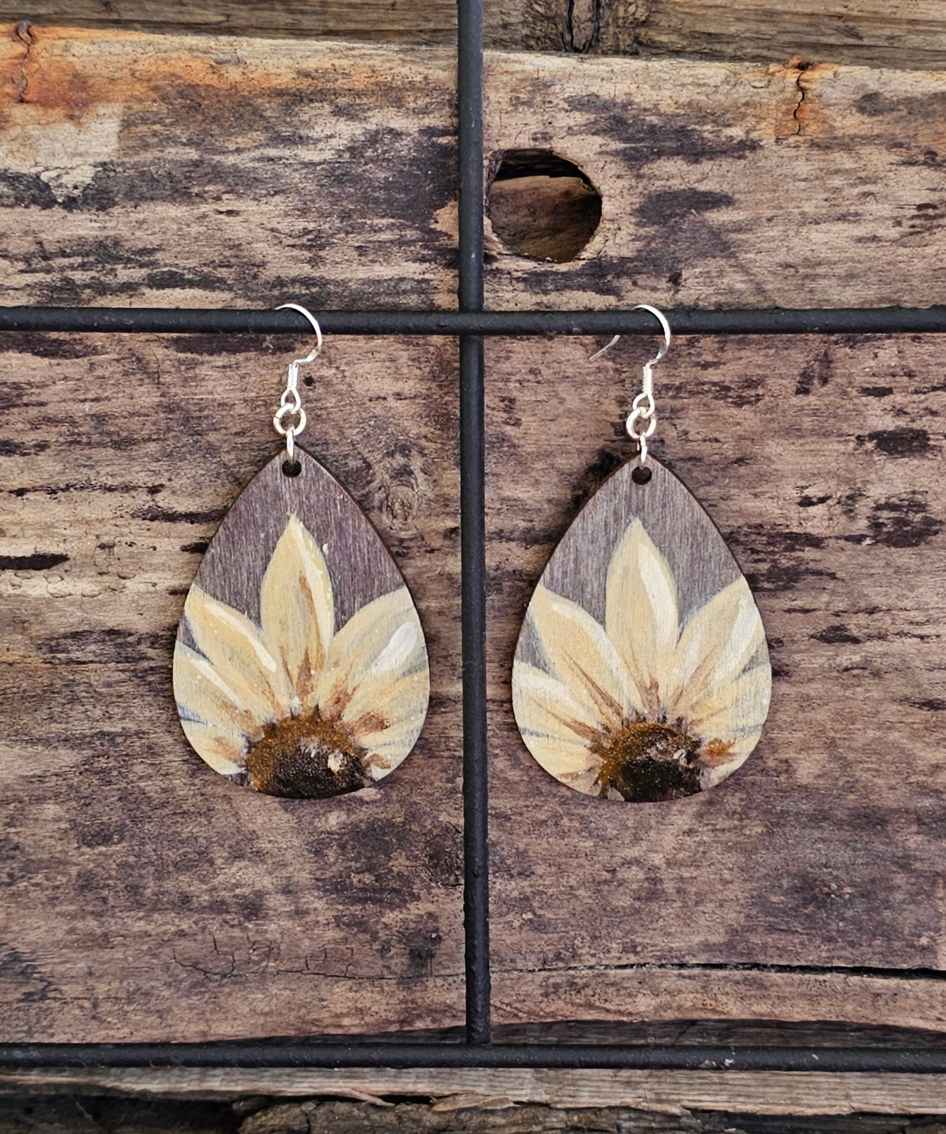 Hand Painted Ultra Lightweight Wooden Earrings. Watercolor and Acrylic. Gray washed painted background with Natural Cream Sunflower. Teardrop in shape. Back is painted in complimentary color. Sterling Silver Findings. Hangs 2 1/4" in Length