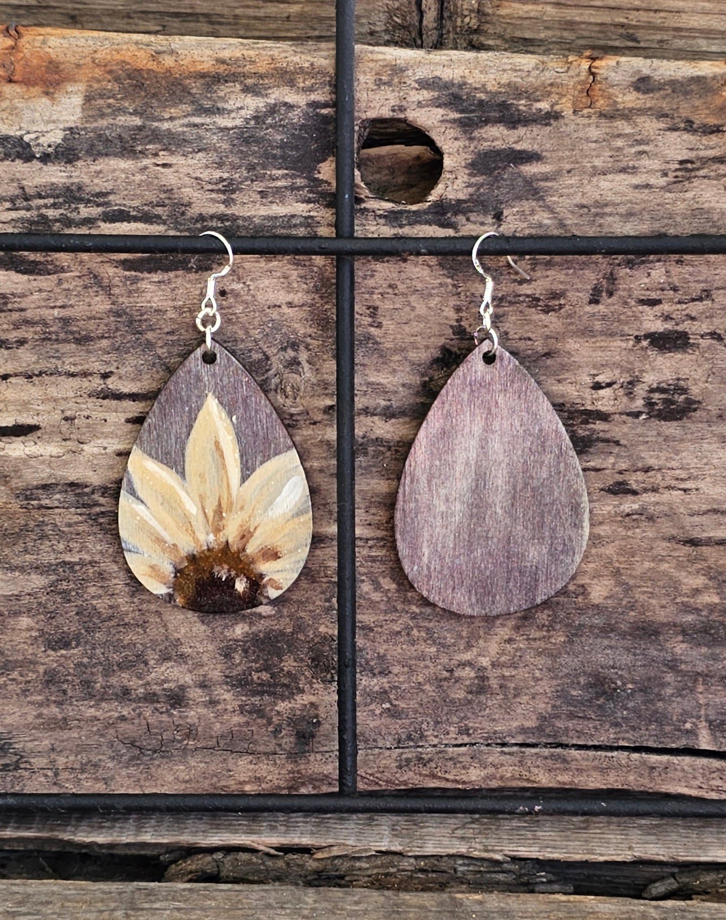 Hand Painted Ultra Lightweight Wooden Earrings. Watercolor and Acrylic. Gray washed painted background with Natural Cream Sunflower. Teardrop in shape. Back is painted in complimentary color. Sterling Silver Findings. Hangs 2 1/4" in Length