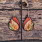 Hand Painted Ultra Lightweight Wooden Earrings. Watercolor and Acrylic. Autumn red background with tan, cream and soft green leaf design. Dark brown painted edge detail. Teardrop in shape. Back is painted in complimentary color. Sterling Silver Findings. Hangs 2 1/4" in Length