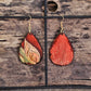 Hand Painted Ultra Lightweight Wooden Earrings. Watercolor and Acrylic. Autumn red background with tan, cream and soft green leaf design. Dark brown painted edge detail. Teardrop in shape. Back is painted in complimentary color. 14kg over Sterling Silver Findings. Hangs 2 1/4" in Length