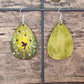 Hand Painted Ultra Lightweight Wooden Earrings. Watercolor and Acrylic.  Multi toned Green colored  background. Dragonfly Fairies, Mystical Forest . Teardrop in shape. Back is painted in complimentary color. Sterling Silver Findings. Hangs 2 1/4" in Length