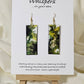 Hand painted watercolor and acrylic ultra lightweight paper earrings. Muted green tones with varying shades of green. Back is painted with similar design and color. Elongated rectangle in shape. 14kg over silver findings. Hangs 2 1/4" in Length