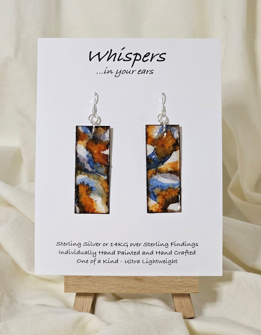 Hand painted watercolor and acrylic ultra lightweight paper earrings. Varied tones of blue, rust and brown.  Back is painted with similar design and color. Elongated rectangle in shape. Sterling silver findings. Hangs 2 1/4" in Length