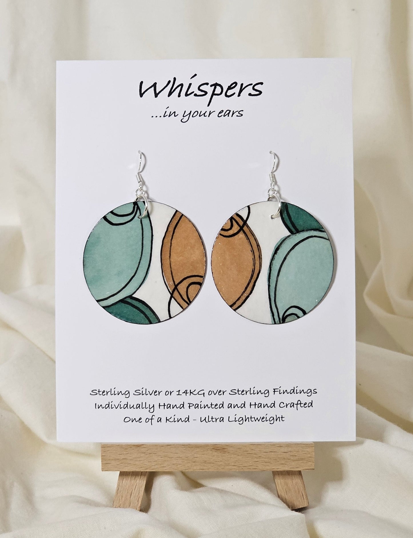 Hand painted watercolor ultra lightweight paper earrings.  Muted teal green and beige semi circles with thin black linear outline. Back is painted with similar color and design.  Circular in shape.  1 3/4 " in Diameter. Sterling silver findings. Hangs 2" in Length