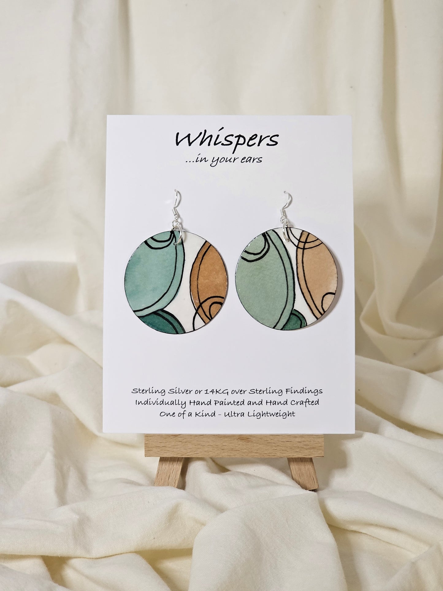 Hand painted watercolor ultra lightweight paper earrings.  Muted teal green and beige semi circles with thin black linear outline. Back is painted with similar color and design.  Circular in shape.  1 3/4 " in Diameter. Sterling silver findings. Hangs 2" in Length