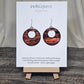 Rustic Faux Wood Circles Hand Painted Paper Earrings. Dark and medium brown in watercolor. Espresso painted edge detail. 1 1/2" Circular in shape with circular cut out.&nbsp; Sterling Silver findings. Hangs 1 3/4" in length