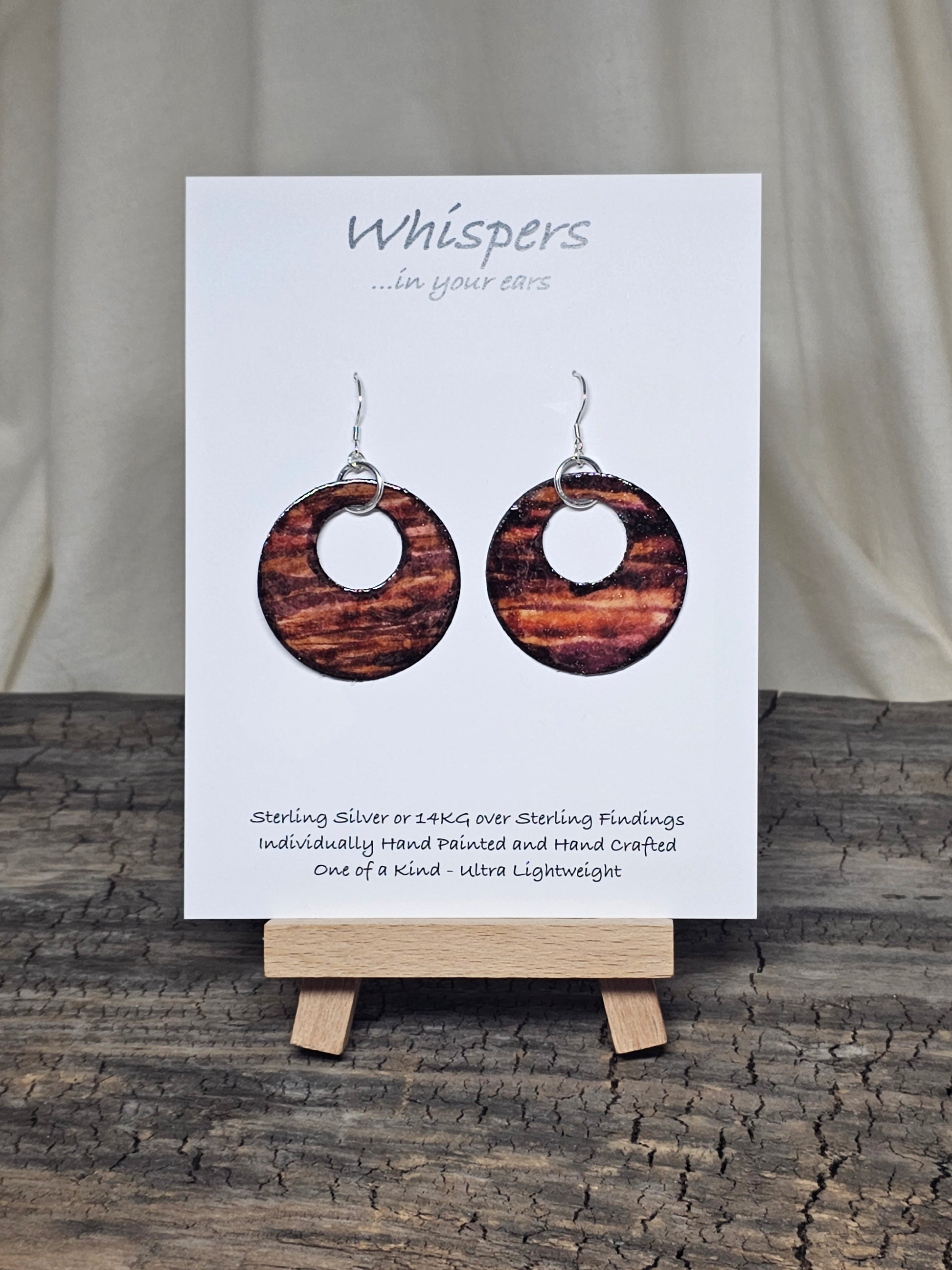 Rustic Faux Wood Circles Hand Painted Paper Earrings. Dark and medium brown in watercolor. Espresso painted edge detail. 1 1/2" Circular in shape with circular cut out.&nbsp; Sterling Silver findings. Hangs 1 3/4" in length