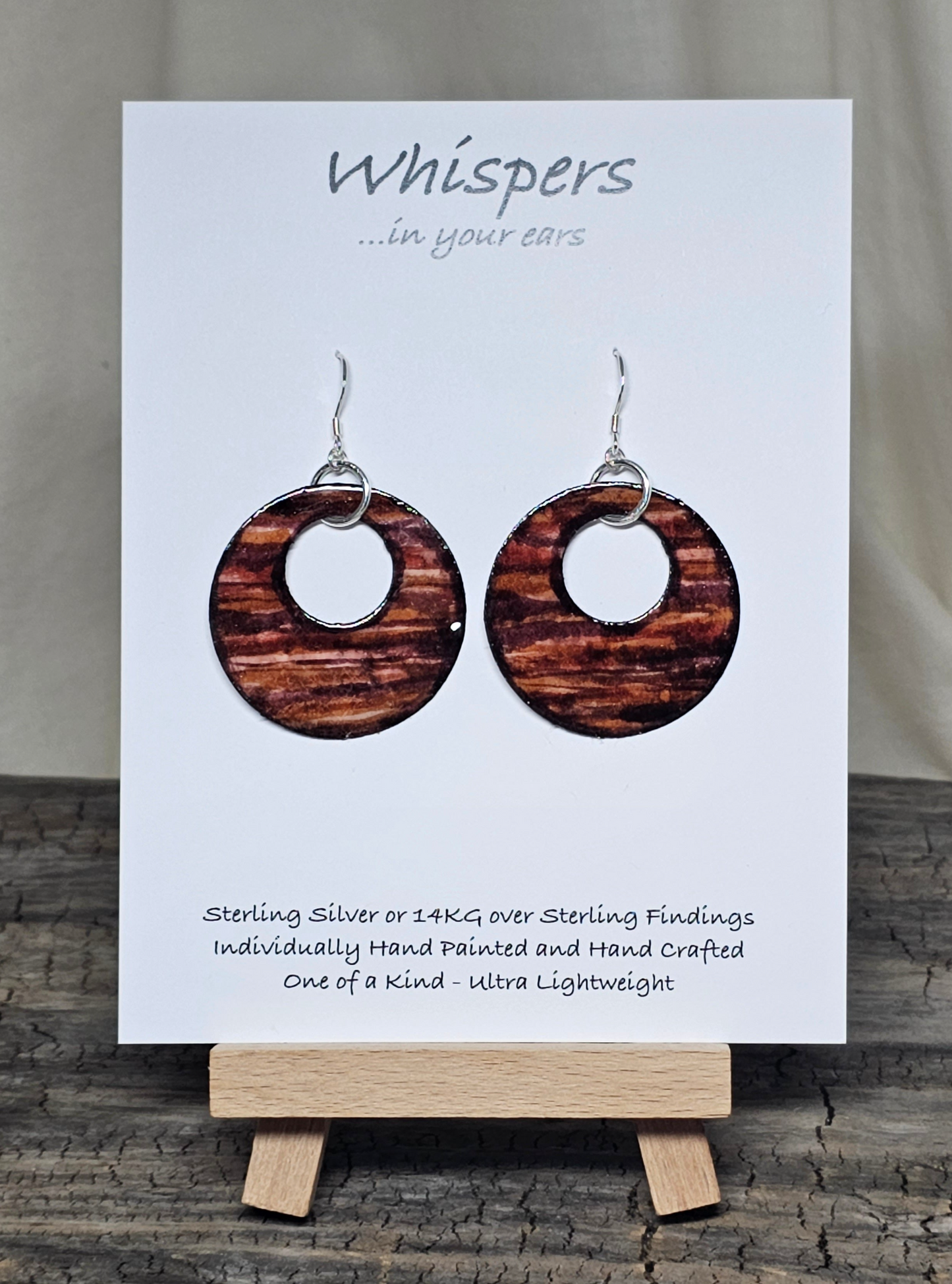 Rustic Faux Wood Circles Hand Painted Paper Earrings. Dark and medium brown in watercolor. Espresso painted edge detail. 1 1/2" Circular in shape with circular cut out.&nbsp; Sterling Silver findings. Hangs 1 3/4" in length