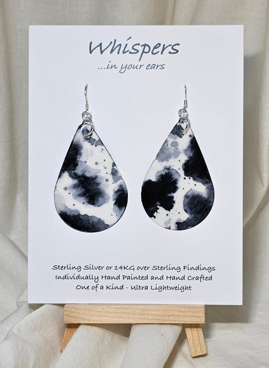 Black Cow Hide hand painted watercolor paper earrings. Ultra lightweight, 2 1/8" Tear Drop.&nbsp; Back is painted to match. Resin coating for durability. Sterling Silver findings. Hangs 2 1/2" in length.