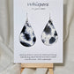 Black Cow Hide hand painted watercolor paper earrings. Ultra lightweight, 2 1/8" Tear Drop.&nbsp; Back is painted to match. Resin coating for durability. Sterling Silver findings. Hangs 2 1/2" in length.