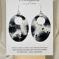 Black n White Cow Hide Print. Hand Painted Paper Earrings. Ultra lightweight, Large statement 2 1/2" Oval. Back is painted to match. Resin coating for durability. Sterling Silver findings. Hangs 2 3/4" in length